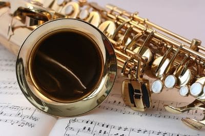 Close-up of a saxophone and sheet music.