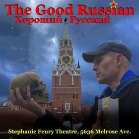 A man holding a skull in front of the Kremlin tower at a theater event.