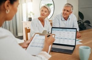 Senior couple consulting a professional with a financial planner.