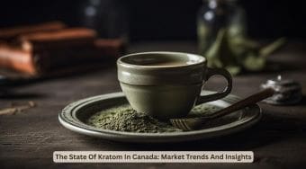 A cup of kratom tea with powdered kratom and a spoon beside it.