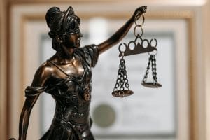 Statue of Lady Justice holding balanced scales.