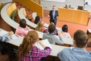 Professor engaging students in a lecture hall discussion.