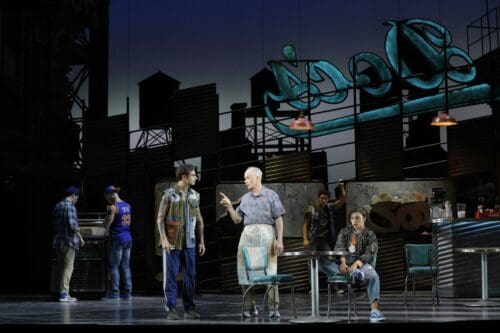 David Prottas as Action, Tom Virtue as Doc, and Anna Bermudez (seated) as Anybodys in LA Opera's 2025 production of West Side Story.