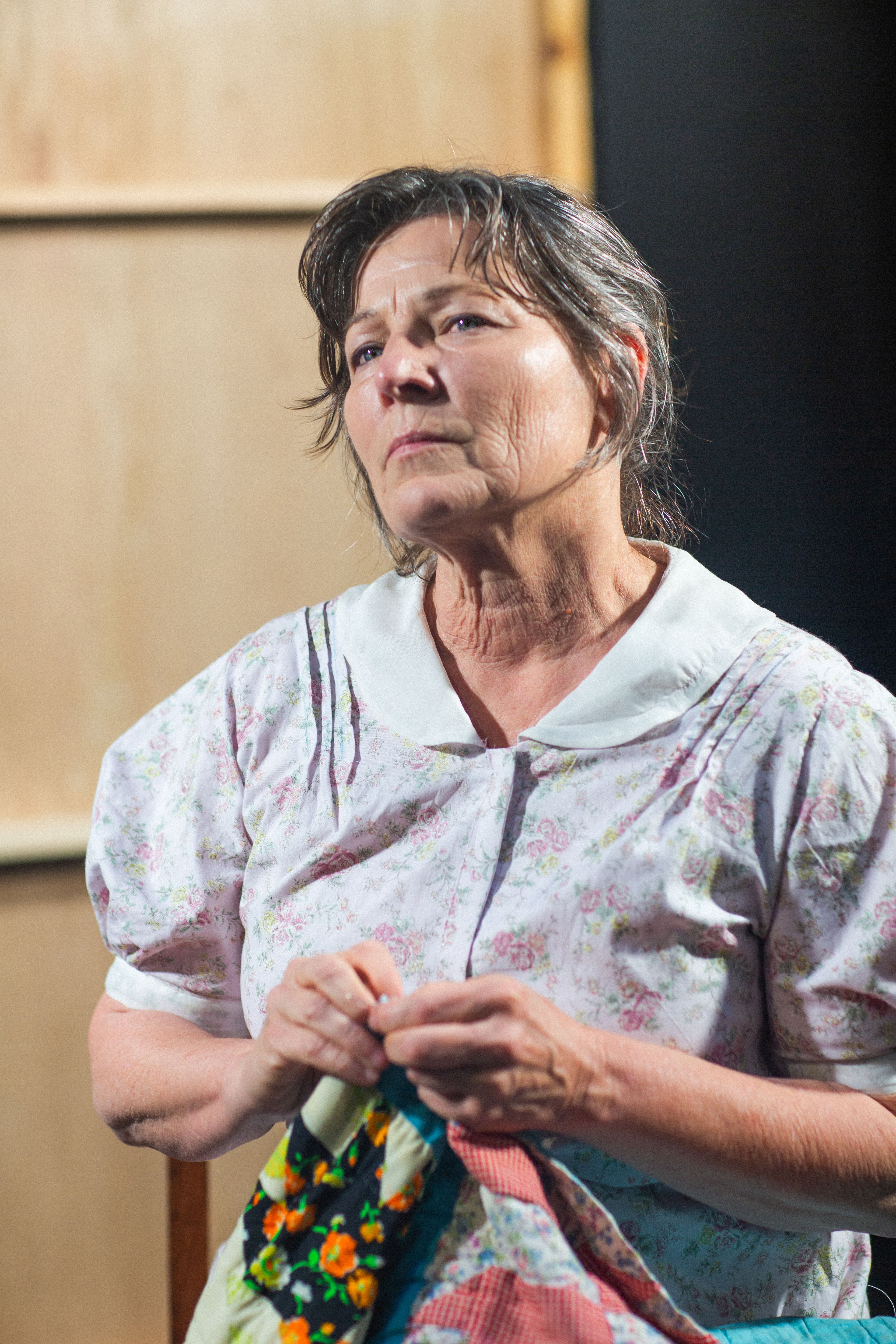 An elderly woman looking thoughtful and concerned.