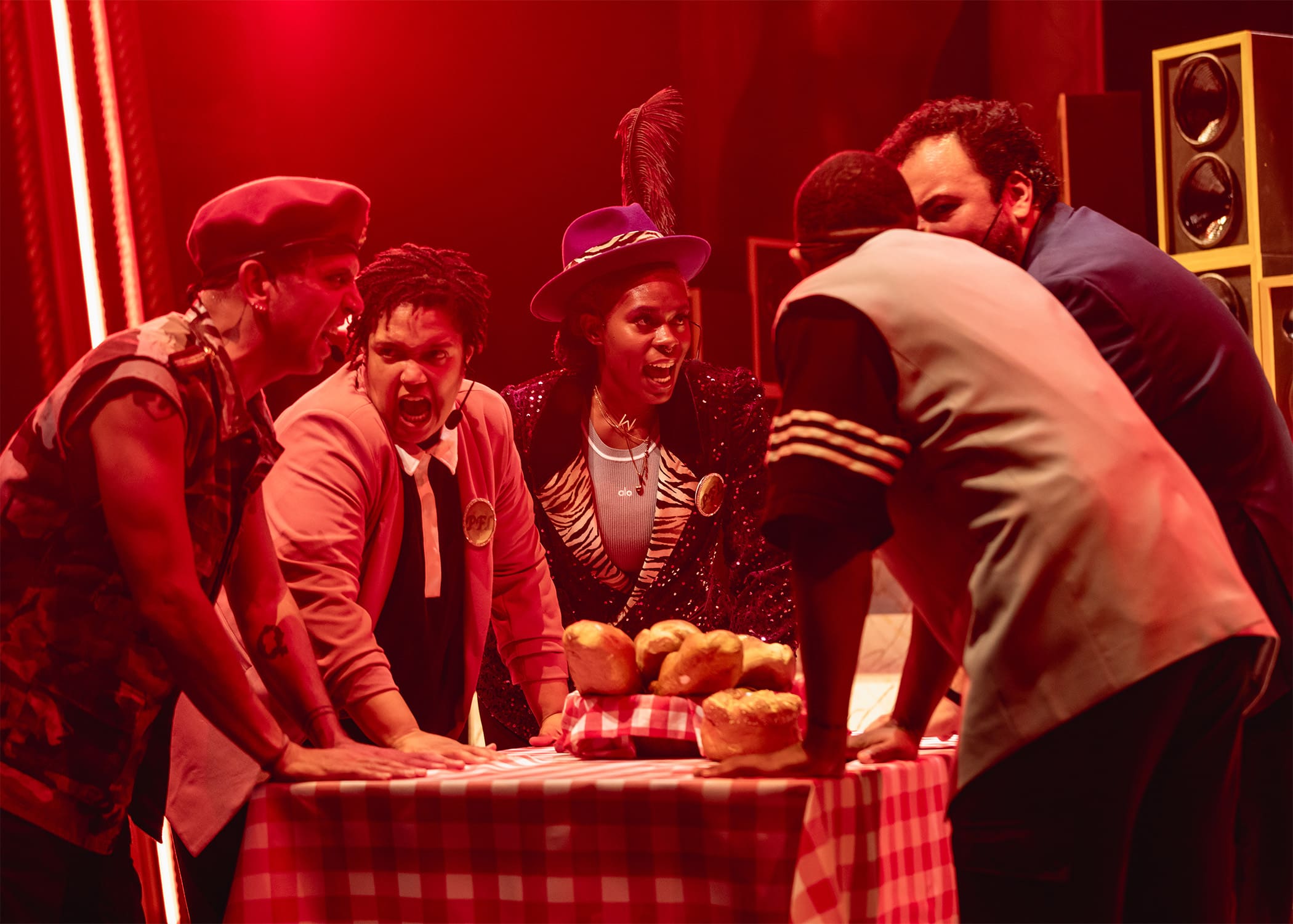 Group of friends enjoying a lively game night around a table with snacks.