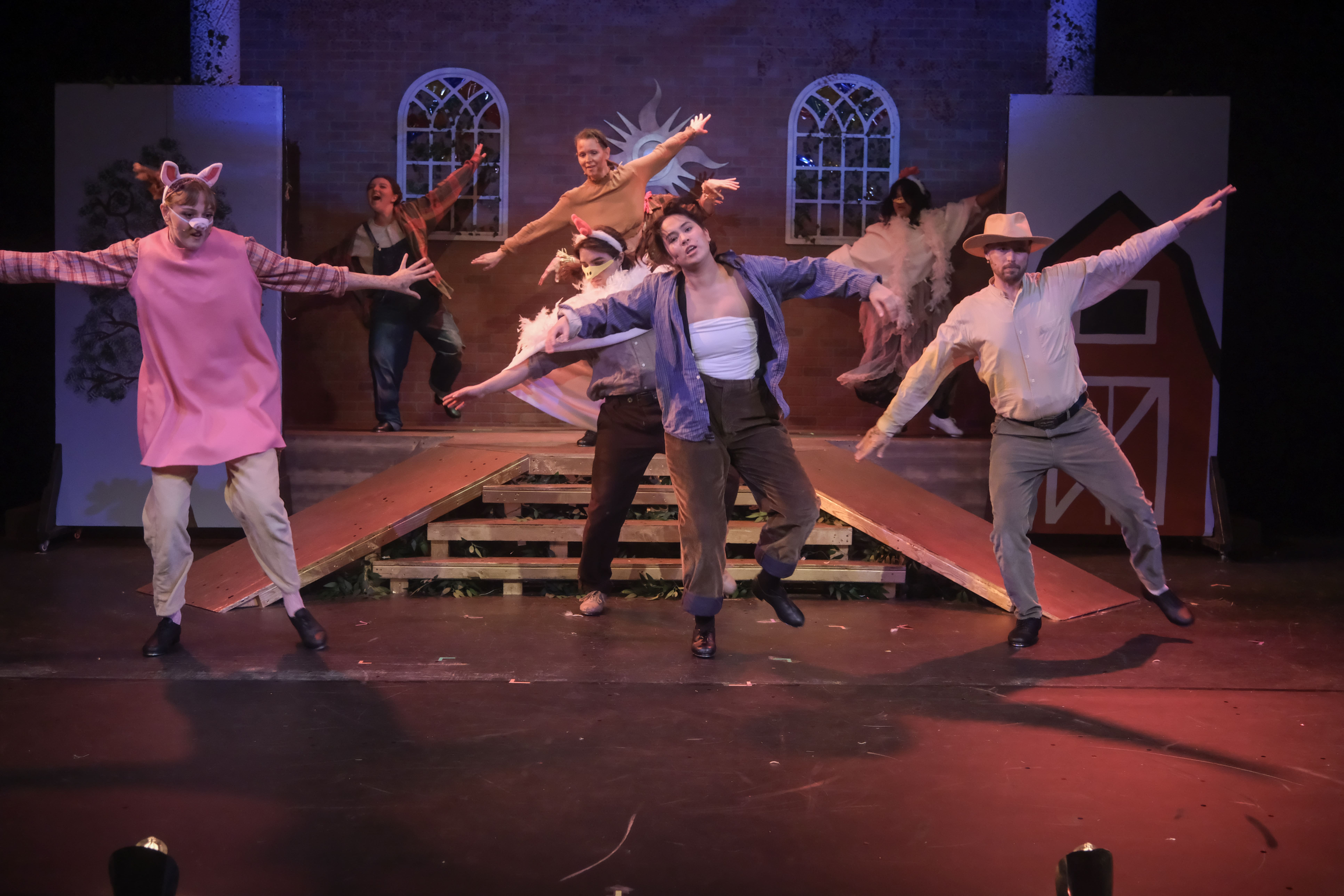 Energetic dance performance with vibrant costumed dancers on stage.