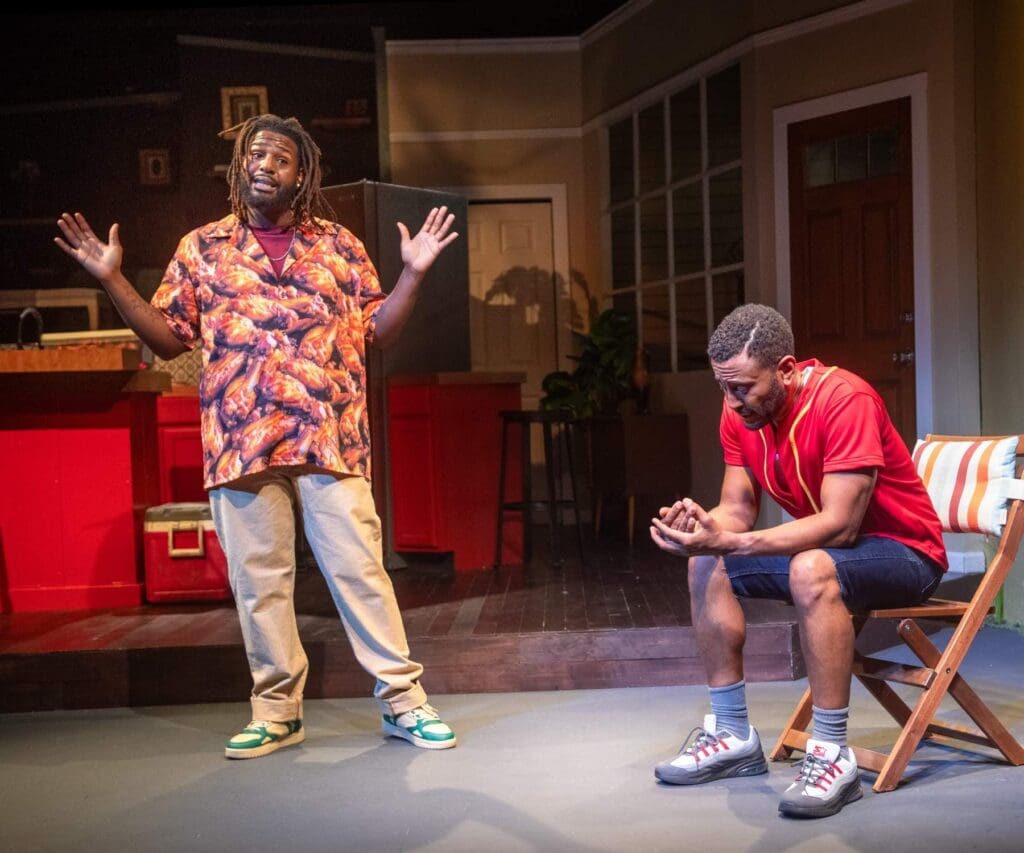 Two men engaged in a lively conversation on stage during a play.