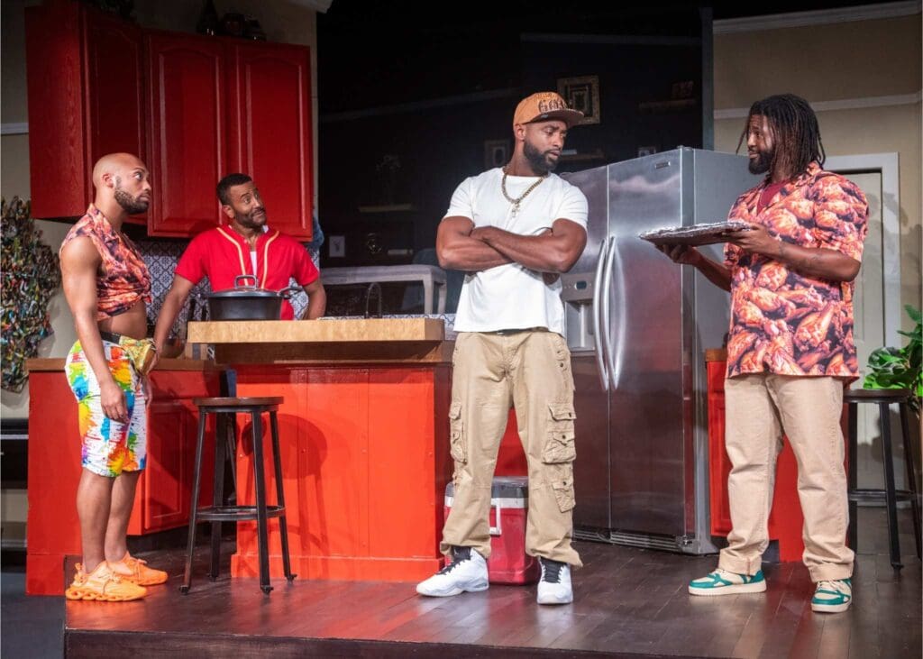 Three men engaged in a lively conversation on a stage with a bar counter.