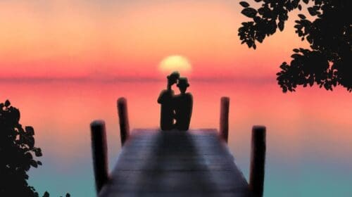 Silhouette of a person sitting on a dock during a sunset over calm water.