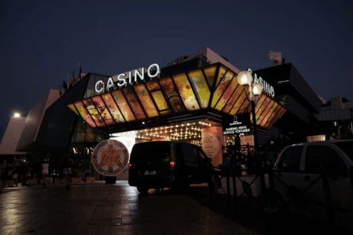 A Casino Entrance Lit Up at Night with Lights