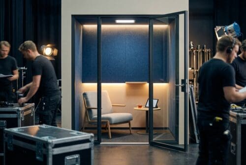 modern-soundproof-booth-with-seating-and-crew-setting-up._
