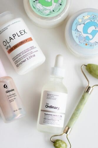 a-white-table-topped-with-bottles-of-skin-care