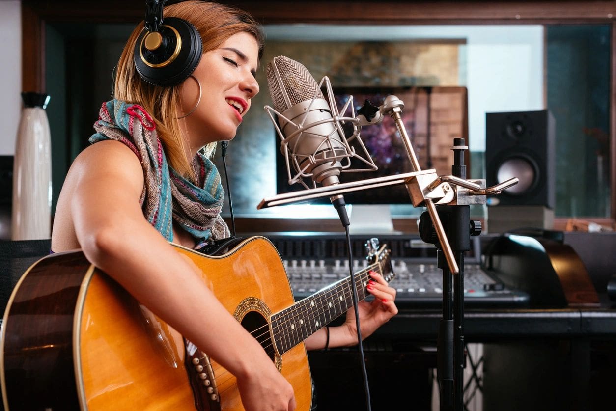 SINGER RECORDING A SONG ON MICROPHONE