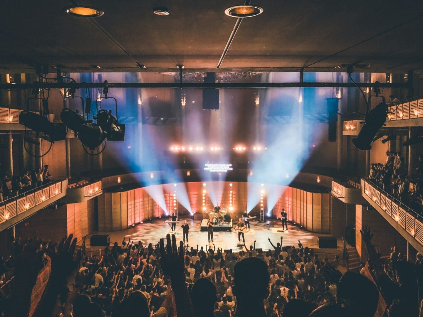 sean-lee-eOYjTbizxBo-unsplash-people-standing-on-stage-with-lights-turned-on-during-nighttime-eOYjTbizxBo